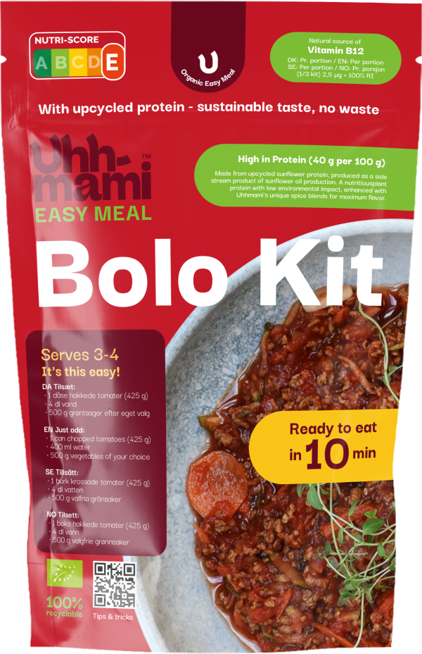 Red packaging for an organic Bolognese kit by Uhmmami, showcasing sustainable, upcycled protein. Bowl of Bolognese with herbs visible.